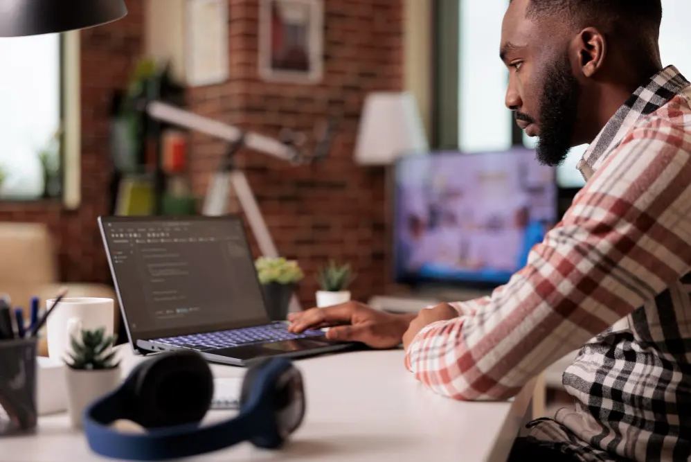 A Programmer Writing Code On A Laptop